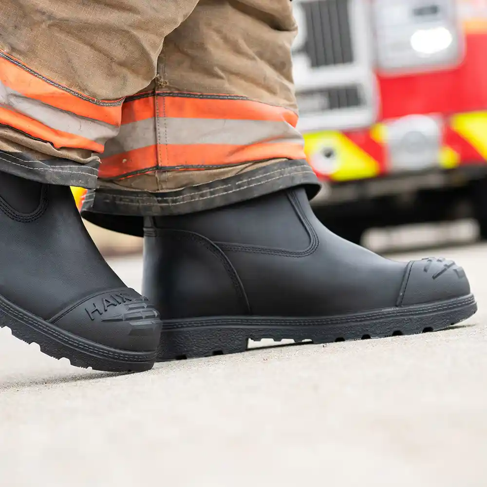 Black Fire Hunter USA firemen boots worn with turnout gear walking on pavement, highlighting cushioned insoles for comfort