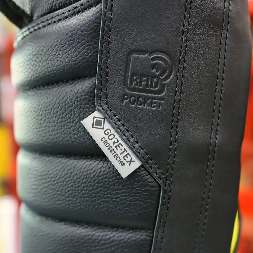 Close-up on CROSSTECH tag of black Fire Eagle Xtreme fire boots, highlighting chemical resistance and waterproof protection.