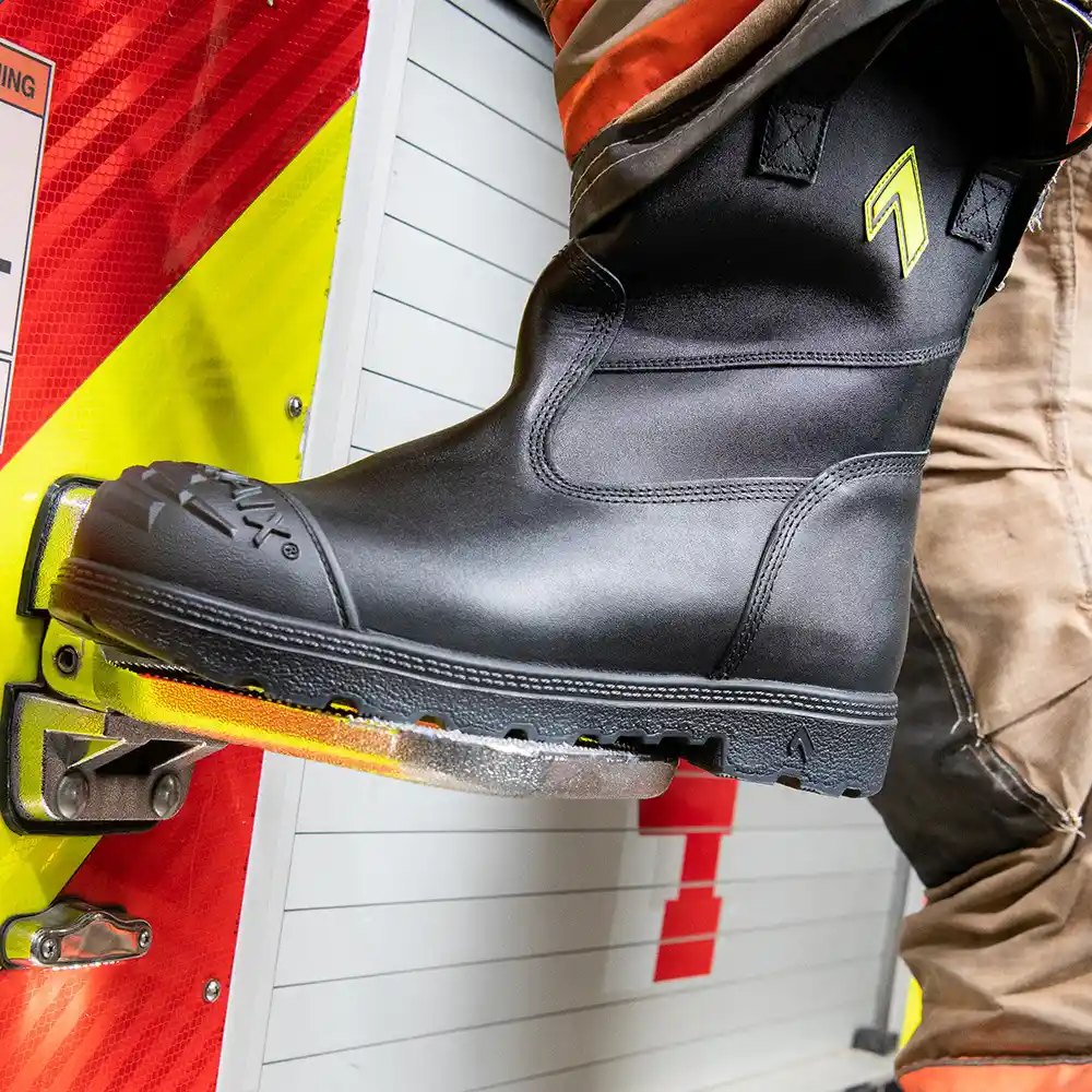 Black Fire Hunter USA leather boots perched on rung of firetruck, featuring a enhanced comfort that surpasses rubber boots