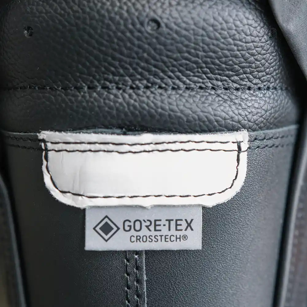 Close-up of CROSSTECH tag of Fire Eagle Air GX bunker boots, highlighting chemical resistance and waterproof protection.