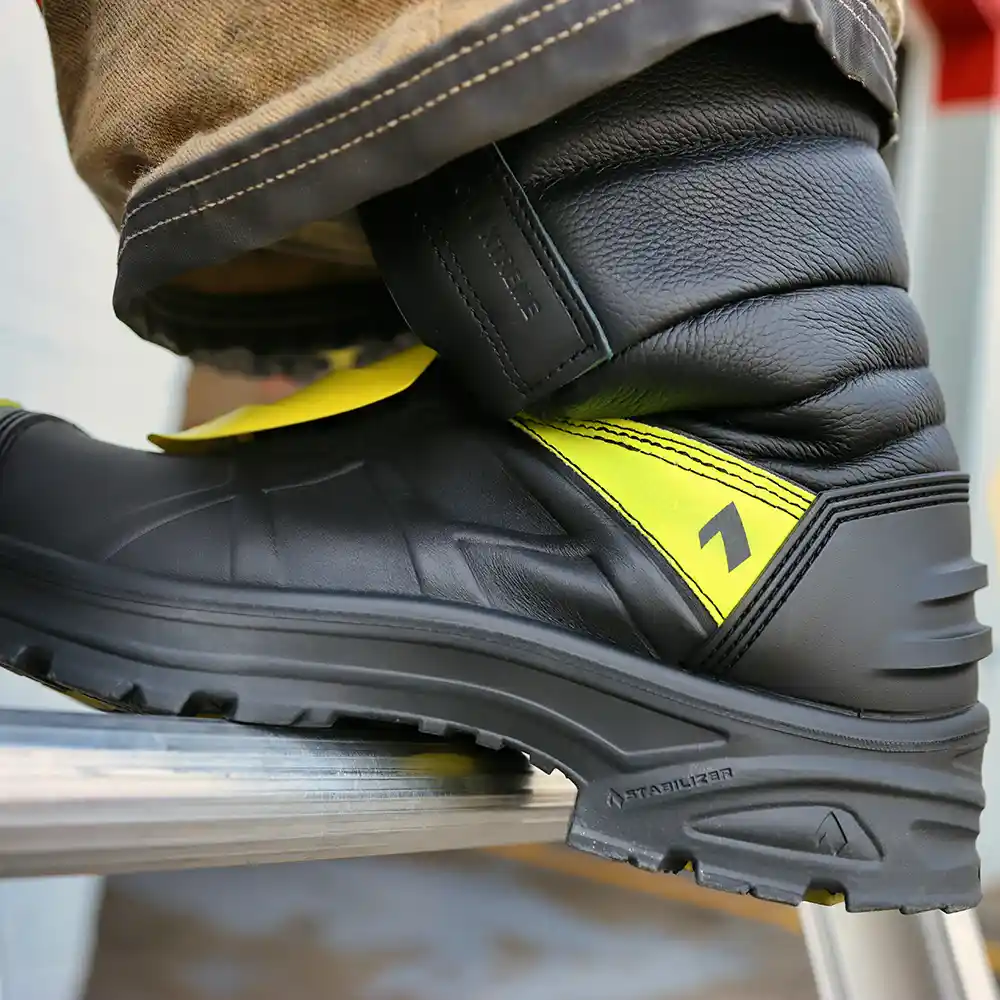Black and yellow Fire Eagle Xtreme HAIX fire boots stepping on a ladder rung, featuring cushioned insole support.