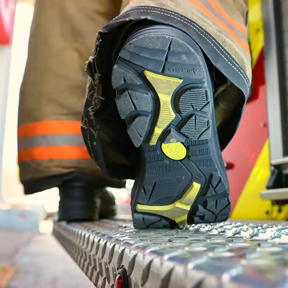 Close-up of Fire Eagle Xtreme in motion with  black and yellow outsole showing, highlighting anti-slip traction.