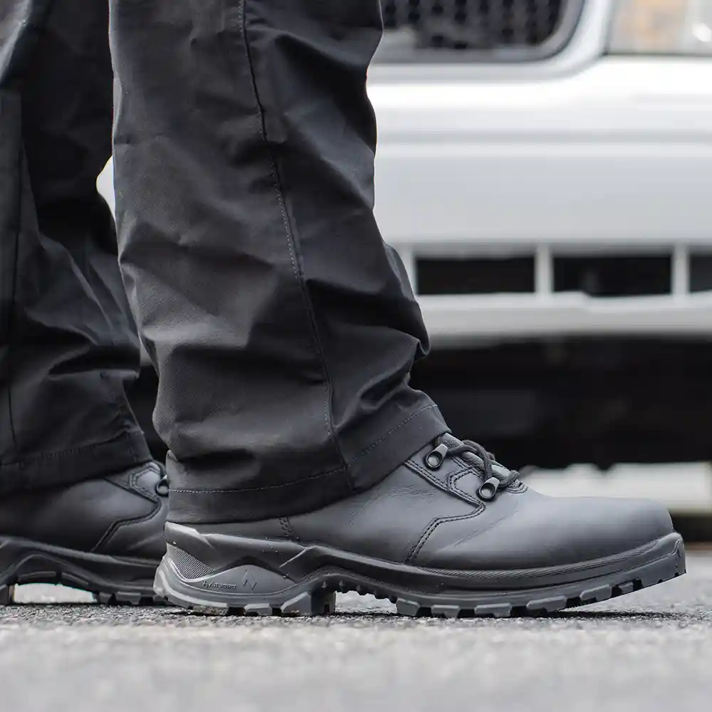 Black Enforce X High Winter boots worn with black uniform pants on top of black pavement, highlighting cushioned comfort.