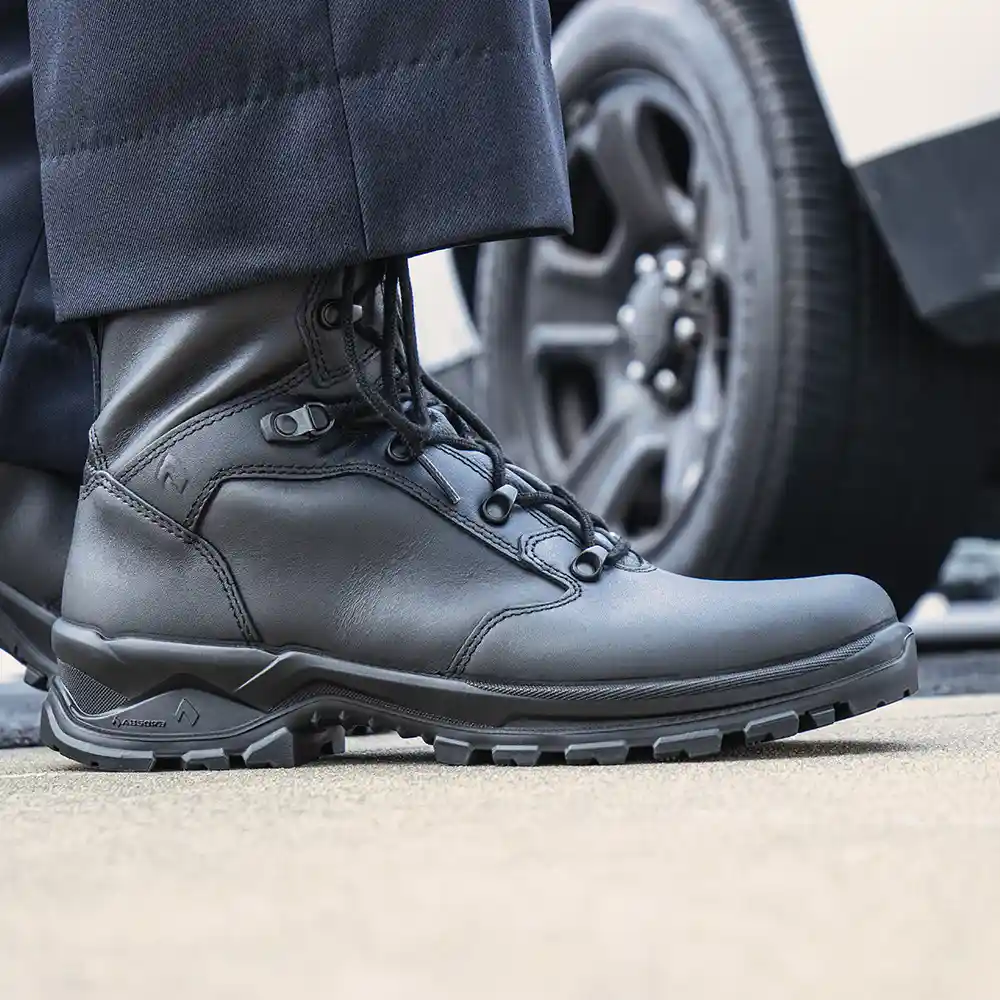 Enforce X High Winter police boots worn with dark blue uniform pants, highlighting climate system for breathable comfort.